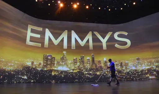 A crew member sweeps the stage during Press Preview Day for the 71st Primetime Emmy Awards in Los Angeles on Sept. 19, 2019. (Photo by Chris Pizzello/Invision/AP, File)