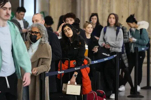Travelers wait in line to board an Amtrak train ahead of the Thanksgiving Day holiday at 30th Street Station in Philadelphia, Wednesday, Nov. 23, 2022. More than 55 million people are expected to travel at least 50 miles from home for Thanksgiving this year. And while misery loves company, there are some steps travelers can take to improve the experience. (AP Photo/Matt Rourke, File)