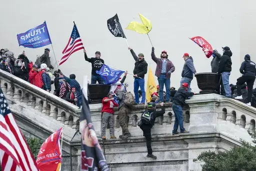 Rioters wave flags on the West Front of the U.S. Capitol in Washington on Jan. 6, 2021. (AP Photo/Jose Luis Magana, File)