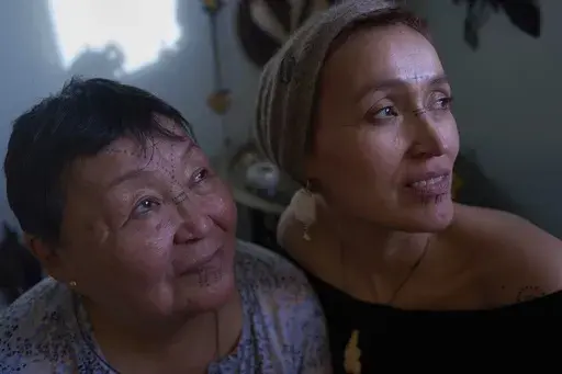 Wearing Inuit facial tattoos, Shaman mother and daughter, Therecie Sanimuinaq Pedersen, left, and Aviaja Rakel Sanimuinaq, pose for a portrait at Aviaja’s studio where she performs Inuit ancestral spiritual healing in Nuuk, Greenland, on Wednesday, Feb. 19, 2025. (AP Photo/Luis Andres Henao)
