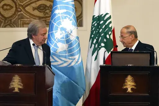 Lebanese President Michel Aoun, right, speaks during a joint press conference with United Nations Secretary-General Antonio Guterres at the presidential palace in Baabda east of Beirut, Lebanon, Sunday, Dec. 19, 2021. (AP Photo/Hassan Ammar)