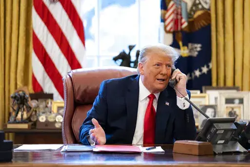 In this image released in the final report by the House select committee investigating the Jan. 6 attack on the U.S. Capitol, on Thursday, Dec. 22, 2022, President Donald Trump talks on the phone to Vice President Mike Pence from the Oval Office of the White House on the morning of Jan. 6, 2021. Congress has passed changes to the arcane law that controls how it ratifies the winner of a presidential election. The legislation is an effort to close loopholes that Trump and his allies tried to explo
