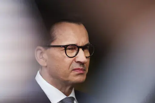 Poland's Prime Minister Mateusz Morawiecki talks to journalists as he arrives for the third EU-CELAC summit in Brussels, Belgium, Tuesday, July 18, 2023. Poland’s ruling party wants to ask voters in a referendum if they support accepting “thousands of illegal immigrants from the Middle East and Africa” as part of a European Union relocation plan. The prime minister announced the referendum question Sunday, Aug. 13, 2023, in a new video published on social media as his conservative party se