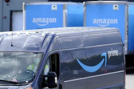 An Amazon Prime logo appears on the side of a delivery van as it departs an Amazon Warehouse location in Dedham, Mass., Oct. 1, 2020. Amazon Prime Day kicks off on Tuesday, July 11, 2023. And, once again, experts are warning consumers of scams. (AP Photo/Steven Senne, File)