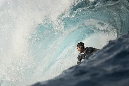 Joao Chianca, of Brazil, surfs on a training day ahead of the 2024 Summer Olympics surfing competition, Tuesday, July 23, 2024, in Teahupo'o, Tahiti. (AP Photo/Gregory Bull)