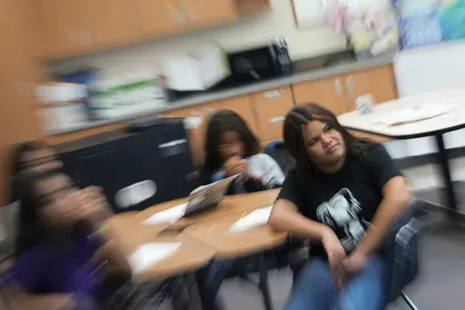 Alisson Ramírez, right, listens to her social studies teacher during class Wednesday, Aug. 28, 2024, in Aurora, Colo. (AP Photo/Godofredo A. Vásquez)