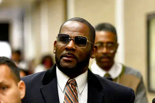 Musician R. Kelly, center, leaves the Daley Center after a hearing in his child support case on May 8, 2019, in Chicago. A Chicago prosecutor said Monday, Jan. 30, 2023, that she's dropping sex-abuse charges against singer R. Kelly, following federal convictions in two courts that ensure the disgraced R&B star will be locked up for decades.(AP Photo/Matt Marton, File)