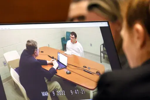 Marjory Stoneman Douglas High School shooter Nikolas Cruz is shown on a courtroom monitor during a videotaped interview with clinical neuropsychologist Dr. Robert L Denney as Dr. Denney testifies during the penalty phase of Cruz's trial at the Broward County Courthouse in Fort Lauderdale, Fla.,  on Thursday, Oct. 6, 2022. Cruz previously plead guilty to all 17 counts of premeditated murder and 17 counts of attempted murder in the 2018 shootings. (Amy Beth Bennett/South Florida Sun Sentinel via A