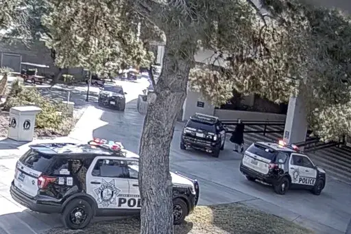 This image from campus surveillance video released by University of Nevada, Las Vegas, Thursday, March 28, 2024, shows gunman Anthony Polito, right, moments before being fatally shot by a UNLV campus police officer on Dec. 6, 2023, on the campus in Las Vegas. (University of Nevada, Las Vegas via AP)