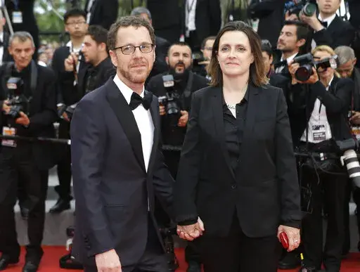 Ethan Coen, left, and Tricia Cooke at the 68th international film festival, Cannes, southern France, Saturday, May 23, 2015. Most in the film industry thought Ethan Coen was done with movies. Ethan did, too. But on Sunday, Coen will premiere his first documentary, "Jerry Lee Lewis: Trouble in Mind," at the Cannes Film Festival. (AP Photo/Lionel Cironneau, File)