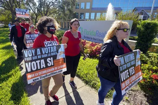 Rent control advocates for Orange County demonstrate in front of the Florida Realtors office building on Oct. 22, 2022, in Orlando, Fla. Ballot measures to build more affordable housing and protect tenants from soaring rent increases were plentiful and fared well in last week's midterm elections. The activity reflected growing angst over record high rents exacerbated by inflation and a dearth of homes. (AP Photo/John Raoux, File)