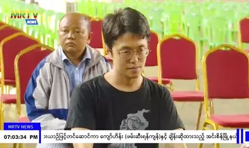 In this image taken from video by Myanmar state broadcaster MRTV, Japanese national Toru Kubota is shown seated during a ceremony inside the Insein prison in Yangon, Myanmar on Thursday, Nov. 17, 2022. Myanmar’s military-controlled government says it is releasing and deporting an Australian academic, a Japanese filmmaker, an ex-British diplomat and an American as part of a broad prisoner amnesty marking the country’s National Victory Day. (MRTV via AP)