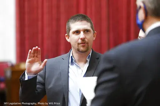 In this image provided by the West Virginia Legislative Photography, Derrick Evans is shown during his swearing-in ceremony to the West Virginia House of Delegates on Dec. 1, 2020, in Charleston, W.Va. Some Jan. 6 defendants who have expressed remorse in court after joining the pro-Trump mob that stormed the Capitol have later struck a different tone or sought to downplay the riot publicly. After pleading guilty to a felony charge in the riot, former West Virginia lawmaker Derrick Evans told a j