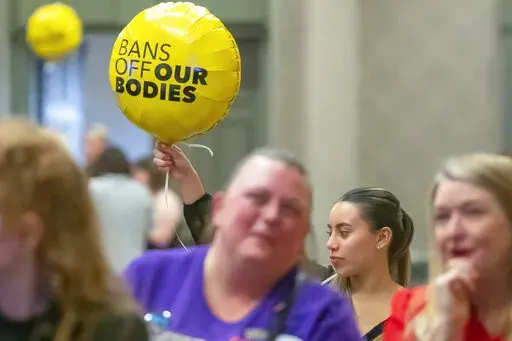 Sarah Gonzalez of Louisville, Ky., holds a balloon at Protect Kentucky Access' election watch party at the Galt House in Louisville, Ky., Tuesday, Nov. 8, 2022. (Ryan C. Hermens/Lexington Herald-Leader via AP)