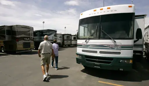 In this June 12, 2007 file photo, shoppers look at recreational vehicles for sale at a dealership in Salt Lake City. Summer is the season to hit the great outdoors, and having a new toy, like a boat or RV, is a dream for many people. But with interest rate hikes, spikes in the cost of oil and general economic uncertainty, you may be hesitant to make a big purchase right now. (AP Photo/Douglas C. Pizac, file)