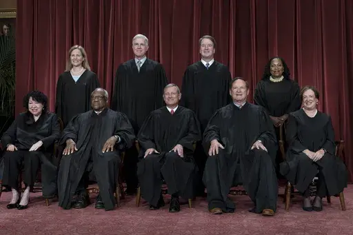 Members of the Supreme Court sit for a group portrait at the Supreme Court building in Washington, Oct. 7, 2022. Bottom row, from left, Justice Sonia Sotomayor, Justice Clarence Thomas, Chief Justice of the United States John Roberts, Justice Samuel Alito, and Justice Elena Kagan. Top row, from left, Justice Amy Coney Barrett, Justice Neil Gorsuch, Justice Brett Kavanaugh, and Justice Ketanji Brown Jackson. As the U.S. Supreme Court is expected to rule on a major case involving former President 