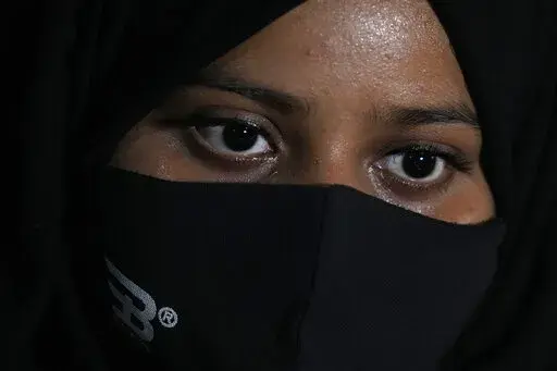 Ayesha Imtiaz, an Indian Muslim student barred from school for wearing hijab sits for an interview with the Associated Press at a cafe in Udupi, Karnataka state, India, Thursday, Feb. 24, 2022. Muslim students in this southern Indian state have found themselves at the center of a debate over hijab bans in schools. Imtiaz, said she wears it as a token of devotion to Islam but acknowledged that opinions vary even among Muslim women. "There are so many of my friends who do not wear hijab inside the