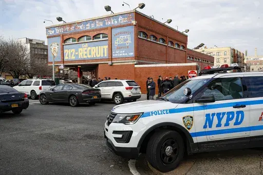 FILE -New York City police officers work the scene of a police involved shooting outside the 41st precinct Sunday, Feb. 9, 2020, in New York. A gunman who ambushed police in New York City twice in 12 hours, wounding two officers, has been sentenced to 23 years to life in prison, Friday, Oct. 20, 2023. (AP Photo/John Minchillo, File)