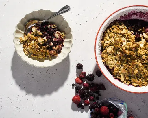 This image released by Milk Street shows a recipe for mixed berry crumble with spiced oats and almonds. (Milk Street via AP)