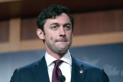 Sen. Jon Ossoff, D-Ga., takes a question from a reporter during a news conference on Capitol Hill in Washington, Sept. 28, 2021. The U.S. Senate is launching a bipartisan working group of lawmakers to scrutinize conditions within the federal Bureau of Prisons in the wake of Associated Press reporting that uncovered widespread corruption and abuse in federal prisons across the U.S. The working group is led by Sen. Jon Ossoff, a Democrat from Georgia and Sen. Mike Braun, an Indiana Republican. (AP