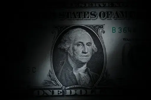 The likeness of George Washington is seen on a U.S. one dollar bill, March 13, 2023, in Marple Township, Pa. We often talk about 401(k)s and 403(b)s as if they’re the same, but they’re not. While both can help you save for retirement, 403(b)s have fewer consumer protections and can be a bad deal for the people — often teachers — they’re supposed to serve. If your employer offers a 403(b), research the plan thoroughly. (AP Photo/Matt Slocum, File)