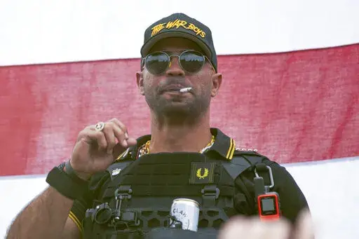 Proud Boys leader Henry "Enrique" Tarrio wears a hat that says The War Boys during a rally in Portland, Ore., on Sept. 26, 2020. Jury selection will get underway Monday, Dec. 19, in the seditious conspiracy trial of former Proud Boys national chairman Enrique Tarrio and four other members of the extremist group accused of plotting to attack the U.S. Capitol on Jan. 6, 2021, in a desperate bid to overturn President Joe Biden's victory. (AP Photo/Allison Dinner, File)