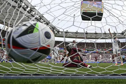 Belgium's Romelu Lukaku, front, scores a disallowed goal during the Group E match between Belgium and Slovakia at the Euro 2024 soccer tournament in Frankfurt, Germany, Monday, June 17, 2024. A high-tech soccer ball that helps with more accurate offside decisions will make its European Championship debut next year in Germany after being used at the 2022 World Cup. (Arne Dedert/dpa via AP, File)