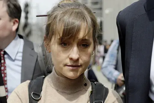 Television actor Allison Mack leaves federal court in the Brooklyn borough of New York, April 8, 2019, after pleading guilty to racketeering charges in a case involving a cult-like group based in upstate New York called NXIVM. Mack has been released from a California prison, according to a government website. Online records maintained by the Federal Bureau of Prisons said she was released Monday, July 3, 2023. (AP Photo/Mark Lennihan, File)