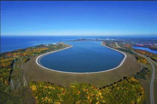 This undated photo provided by Consumers Energy shows an aerial view of the Ludington Pumped Storage Plant near Ludington, Mich. The plant generates electricity by pumping water from Lake Michigan to a reservoir on top of a bluff, then releasing it through giant turbines as needed. Advocates of pumped storage call such facilities the "world's largest batteries." (AP Photo/Consumers Energy)