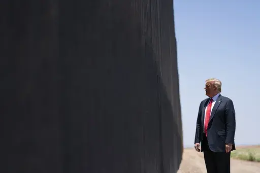 President Donald Trump tours a section of the border wall in San Luis, Ariz., June 23, 2020. (AP Photo/Evan Vucci, File)