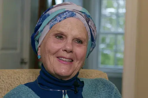 In this image taken from video, Lynda Bluestein smiles during an interview in the living room of her home, Feb. 28, 2023, in Bridgeport, Conn. Bluestein, who pushed for expanded access to Vermont's law that allows people who are terminally ill to receive lethal medication to end their lives, died in Vermont on Thursday, Jan. 4, 2024. Bluestein had terminal cancer and ended her life by taking prescribed medication. (AP Photo/Rodrique Ngowi, File)