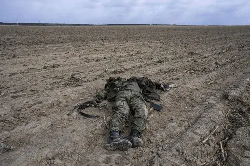 A Russian soldier killed during combats against Ukrainian army lies on a corn field in Sytnyaky, on the outskirts of Kyiv, Ukraine, Sunday, March 27, 2022. Nearly 50,000 Russian soldiers have died in the war in Ukraine, according to a new statistical analysis. (AP Photo/Rodrigo Abd, File)