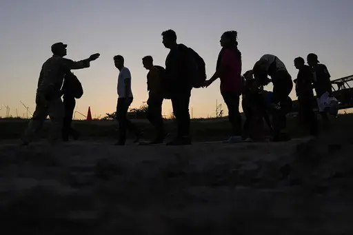 Migrants who crossed the Rio Grande and entered the U.S. from Mexico are lined up for processing by U.S. Customs and Border Protection, Sept. 23, 2023, in Eagle Pass, Texas. U.S. authorities say border arrests during July have plummeted to a new low for Joe Biden’s presidency, raising prospects that a temporary ban on asylum may be lifted soon. The Border Patrol is expected to arrest migrants about 57,000 times during the month, down about 30% from June and the lowest tally since September 202