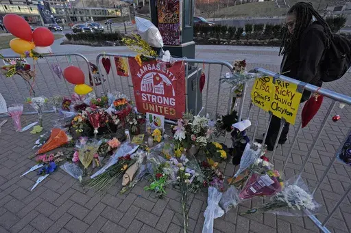A person views a memorial dedicated to the victims of last week's mass shooting in front of Union Station, Sunday, Feb. 18, 2024, in Kansas City, Mo. Missouri prosecutors said Tuesday, Feb. 20, that two men have been charged with murder in last week’s shooting that killed one person and injured multiple others after the Kansas City Chiefs’ Super Bowl parade. (AP Photo/Charlie Riedel, File)