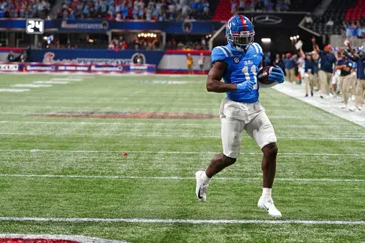 Mississippi wide receiver Dontario Drummond (11) scores after making a catch during the second half of an NCAA college football game against Louisville Monday, Sept. 6, 2021, in Atlanta. (AP Photo/John Bazemore)