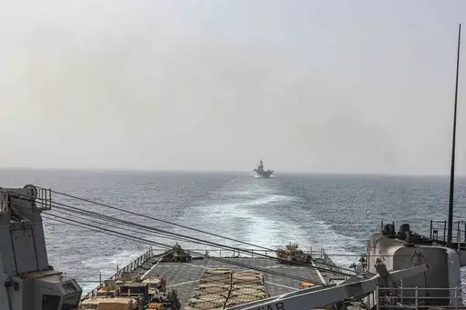 In this image provided by the U.S. Navy, the amphibious dock landing ship USS Carter Hall and amphibious assault ship USS Bataan transit the Bab al-Mandeb strait on Aug. 9, 2023. The top commander of U.S. naval forces in the Middle East says Yemen’s Houthi rebels are showing no signs of ending their “reckless” attacks on commercial ships in the Red Sea. But Vice Adm. Brad Cooper said in an Associated Press interview on Saturday that more nations are joining the international maritime missi