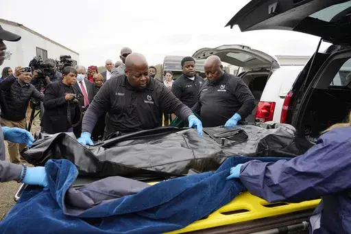 Westhaven Memorial Funeral Home staff adjust the body bag with the remains of Dexter Wade, who died after being hit by a Jackson, Miss., police SUV driven by an off-duty officer, in Raymond, Miss., Nov. 13, 2023. A third family says they recently discovered a relative was buried in a Mississippi pauper’s cemetery without their knowledge. Civil rights attorney Ben Crump says it is the latest case in which families learned the whereabouts of a deceased loved one from news reports instead of from