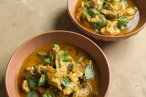 This image released by Milk Street shows a recipe for braised chicken with fennel and saffron. (Milk Street via AP)